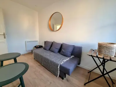 a living room with a couch and a mirror at Appartement climatisation centre historique in Aix-en-Provence