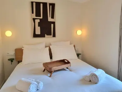 a bedroom with two beds with towels on the bed at MAYU MAYU - cocon centre-ville climatisation in Aix-en-Provence