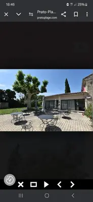 a picture of a patio with tables and chairs at Hôtel PRATO PLAGE in Pernes-les-Fontaines