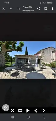 a screenshot of a picture of a building with tables at Hôtel PRATO PLAGE in Pernes-les-Fontaines