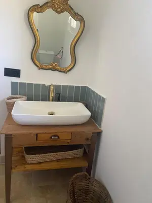 a bathroom with a sink and a mirror on the wall at Villa Augustine in Ventabren
