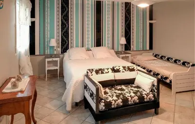 a bedroom with a bed and a chair in it at Nice Home In Carpentras in Carpentras