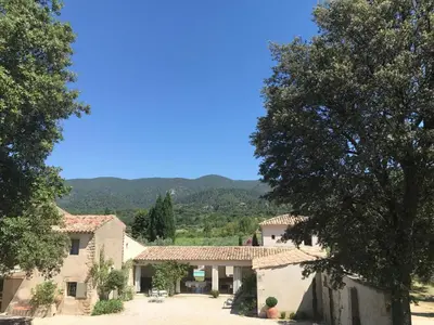 a view of a house with mountains in the background at La Grande Bastide in Vaugines