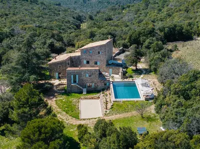 an aerial view of an old house with a swimming pool at Evasion Luberon in Murs