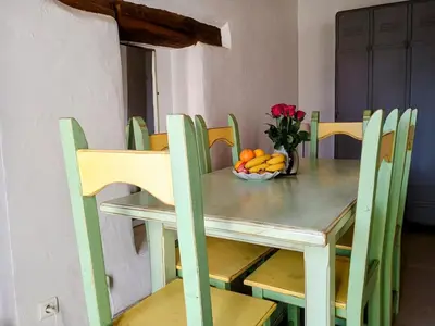 a table with a bowl of fruit and flowers on it at Gîte 33 ha Piscine Activités Vue in Saumane-de-Vaucluse