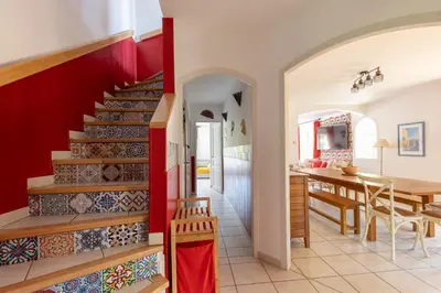 a kitchen and dining room with a staircase in a house at Universo private pool and large garden in Pernes-les-Fontaines