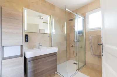a bathroom with a sink and a glass shower at Universo private pool and large garden in Pernes-les-Fontaines