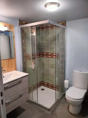 a bathroom with a shower with a toilet and a sink at GitesLuberon 2 F2 in Charleval