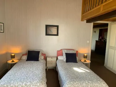 two beds in a room with two lamps on tables at Villa CHATEAU SAINTE BARBE in Loriol-du-Comtat
