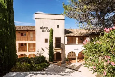 a building with a sign that reads motel oil lease at Résidence Hôtel du Golf de Pont Royal - maeva Home - Appartement avec jardin 2 pièces 4 personnes - Prestige - super Home MAE-8891 in Mallemort