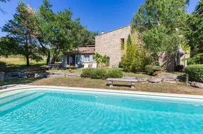 a large swimming pool in front of a house at Maison de James in Murs
