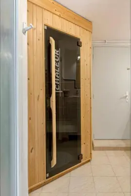 a room with a glass door in a wooden wall at Maison de James in Murs
