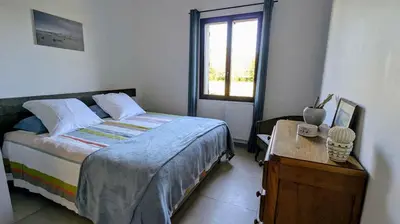 a small bedroom with a bed and a window at Gîte le Micocoulier in Carpentras