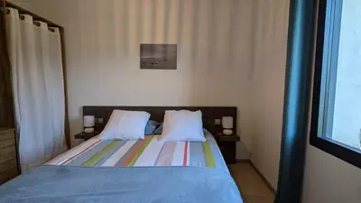 a bedroom with a bed with two pillows at Gîte le Micocoulier in Carpentras