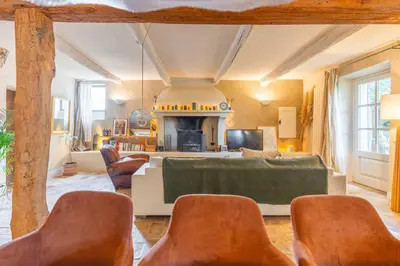 a living room with a table and some chairs at Mas provençal, entre vignes et oliviers in Lambesc