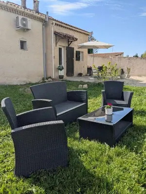 a group of chairs and a table in a yard at Gîte The Butterfly - 1 bedroom and mezzanine in Monteux