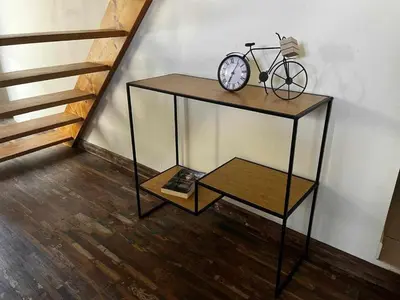 a table with a bike on it next to a staircase at Gîte The Butterfly - 1 bedroom and mezzanine in Monteux