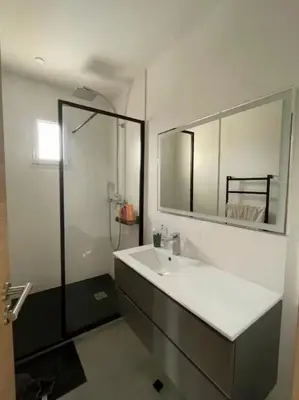 a bathroom with a sink and a mirror and a shower at Villa avec vue sur le pilon du roi in Aix-en-Provence