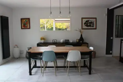 a dining room with a wooden table and chairs at Villa avec vue sur le pilon du roi in Aix-en-Provence