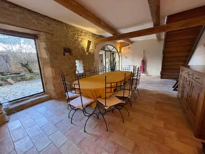 a dining room with a table and chairs at Les 2 voûtes - Mas provençal pour 10 personnes in Oppède