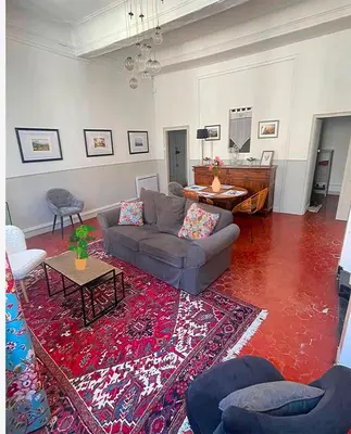 a living room with a couch and a rug at Inactif in Aix-en-Provence