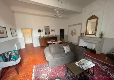 a living room with a couch and a table at Inactif in Aix-en-Provence