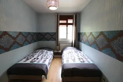 two beds in a small room with a window at PROVENCE VAUCLUSE VELLERON Superbe maison avec piscine tout confort in Velleron