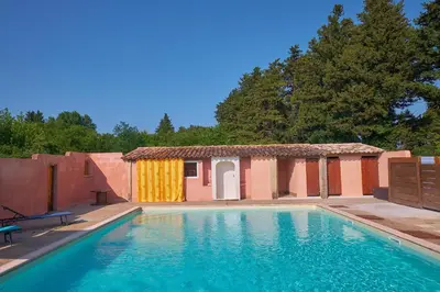a swimming pool in front of a house at Maison provençale avec jardin in Velleron