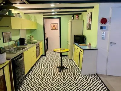 a kitchen with a table in the middle of it at Atypical 5-person house with patio, downtown, air-conditioning in Aix-en-Provence