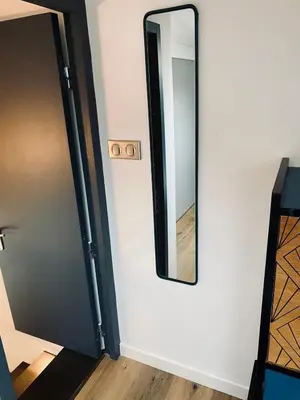 a mirror on a wall next to a door at Atypical 5-person house with patio, downtown, air-conditioning in Aix-en-Provence