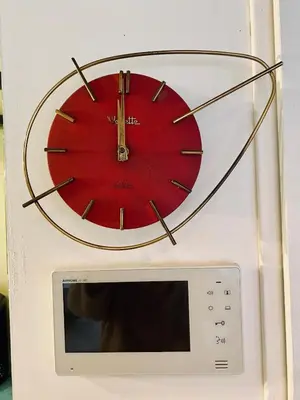 a red clock is on top of a microwave at Atypical 5-person house with patio, downtown, air-conditioning in Aix-en-Provence