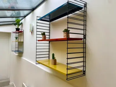 a shelf on a wall with plants on it at Atypical 5-person house with patio, downtown, air-conditioning in Aix-en-Provence