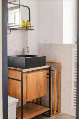 a kitchen with a black sink in a room at Coudignac 1891 in Lagnes