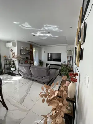 a living room with a couch and a table at bel appartement T3 Aix Nord in Aix-en-Provence
