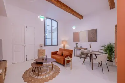 a living room with a couch and two tables at Appartement Belle Lettre 5 in Aix-en-Provence