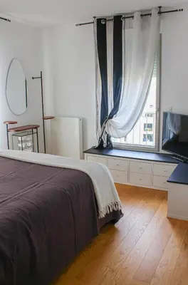 a bedroom with a bed and a large window at Spacious Duplex with Terrace City Center in Aix-en-Provence