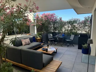 a patio with a couch and tables and plants at Spacious Duplex with Terrace City Center in Aix-en-Provence