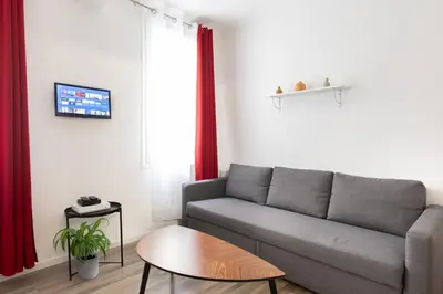 a living room with a couch and a table at Le Cézanne - Studio Hypercentre - Wifi - Train station in Aix-en-Provence