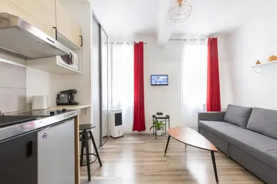 a kitchen and a living room with a couch at Le Cézanne - Studio Hypercentre - Wifi - Train station in Aix-en-Provence