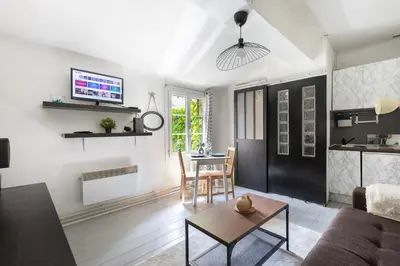 a living room with a couch and a table at Le Mirabeau - Hypercenter studio - Wifi - Train station in Aix-en-Provence