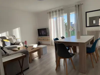 a bedroom with a bed and a pendant light at Appartement Lumineux avec Balcon in Carpentras