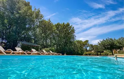 a swimming pool with lounge chairs in a yard at Lovely Home In St Cannat in Saint-Cannat