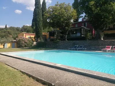 a swimming pool in front of a house at Maisonnette dans un parc du 18ème in Aix-en-Provence