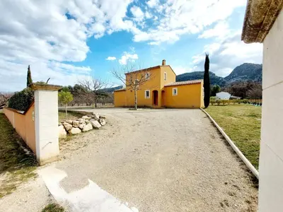 a yellow house with a driveway in front of it at En Provence, Luberon, villa avec piscine à Maubec in Maubec