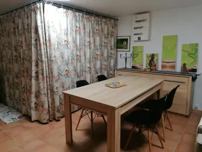 a dining room with a wooden table and chairs at Les chênes du lac in Saint-Saturnin-les-Apt