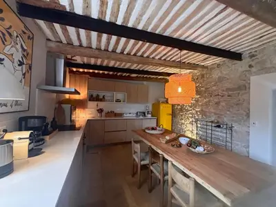 a kitchen with a wooden table in a room at Brin d'Olivier en Luberon in Gargas