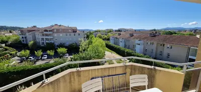 a balcony with chairs and buildings in a city at Le Belvédère, Air Conditioning, Freepark 6p in Aix-en-Provence