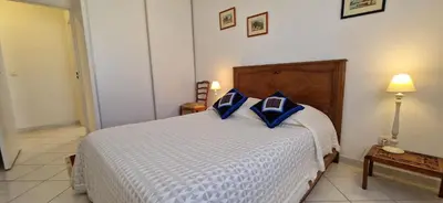 a bedroom with a bed with blue pillows on it at Le Belvédère, Air Conditioning, Freepark 6p in Aix-en-Provence