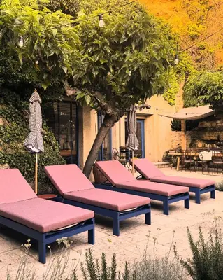 a row of benches sitting next to a tree at CaBaNa 52 La Suite troglodyte Proche Lourmarin in Cadenet