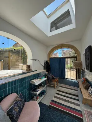 a living room with a couch and a window at CaBaNa 52 La Suite troglodyte Proche Lourmarin in Cadenet